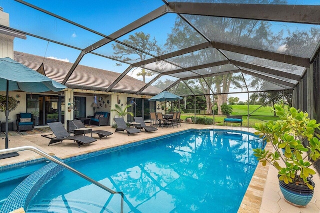 view of swimming pool with glass enclosure and a patio