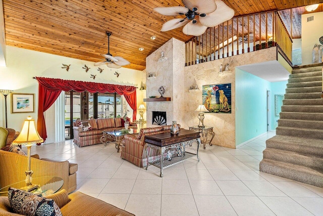 living room featuring ceiling fan, light tile patterned flooring, a fireplace, and high vaulted ceiling