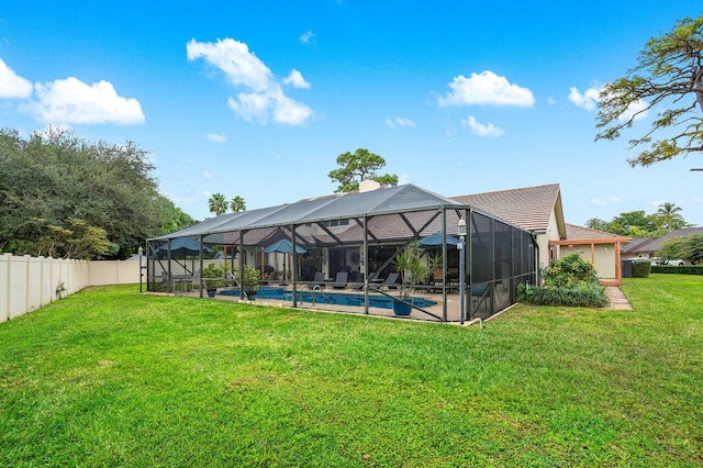 exterior space with glass enclosure, a fenced in pool, and a lawn