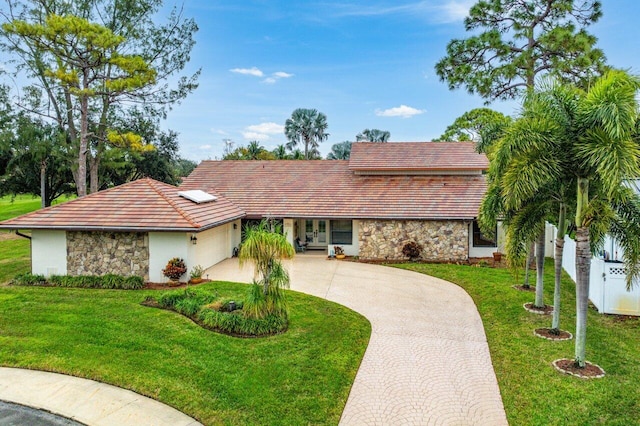 single story home with a front yard and a garage