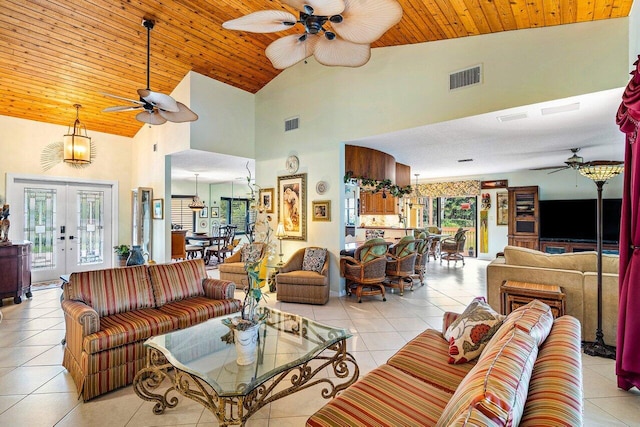 tiled living room featuring high vaulted ceiling, wooden ceiling, ceiling fan, and french doors