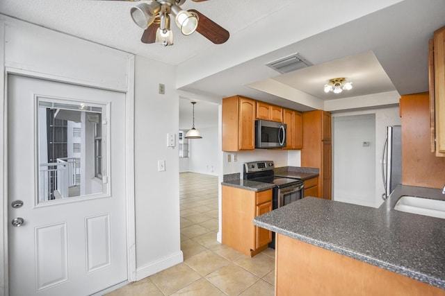 kitchen featuring appliances with stainless steel finishes, ceiling fan, sink, light tile patterned floors, and decorative light fixtures