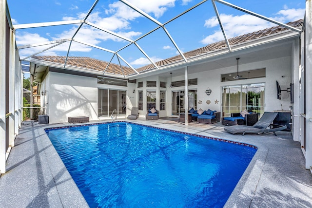 rear view of house featuring a lanai, ceiling fan, an outdoor living space, and a patio