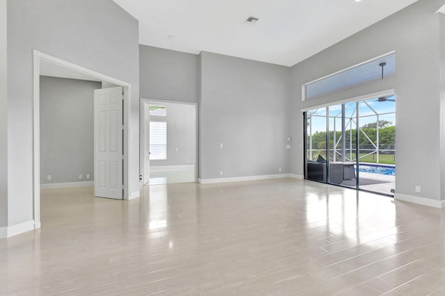 unfurnished room with a towering ceiling