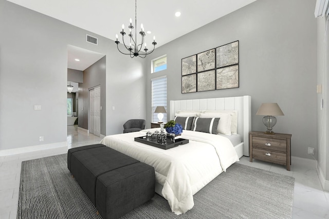 bedroom with a closet, multiple windows, and a notable chandelier