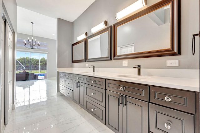 bathroom with a chandelier and vanity