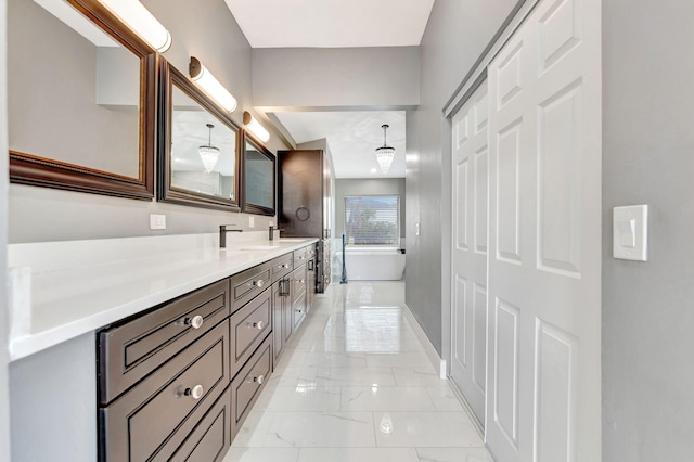 bathroom featuring a tub to relax in and vanity