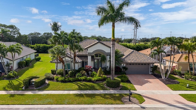 mediterranean / spanish-style home with a front lawn and a garage