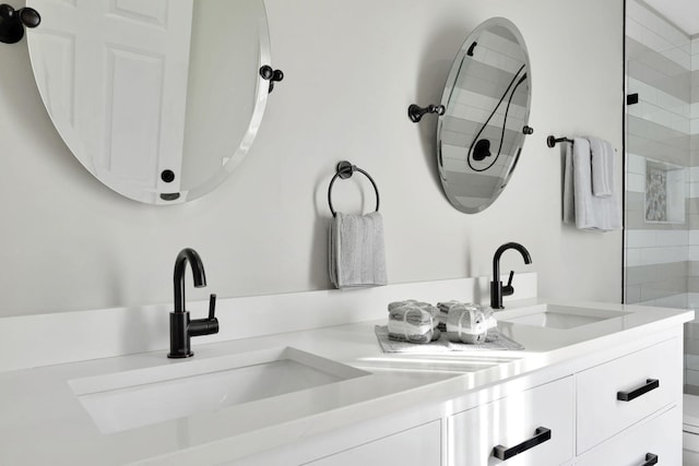 bathroom featuring walk in shower and vanity