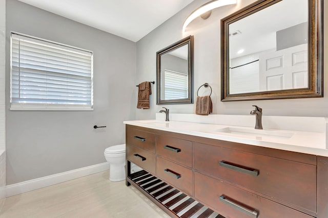 bathroom featuring toilet and vanity