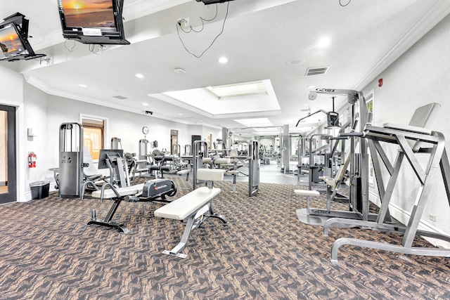 gym featuring a textured ceiling, crown molding, and carpet flooring