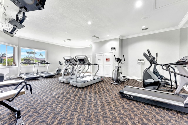 gym featuring a textured ceiling and ornamental molding