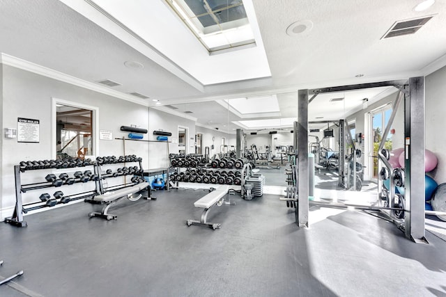 workout area with a textured ceiling and crown molding