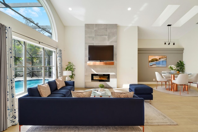 living room with light hardwood / wood-style flooring and a tiled fireplace