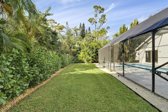 view of yard with a lanai and a patio