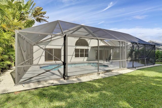 rear view of property featuring a lanai, a patio area, and a yard