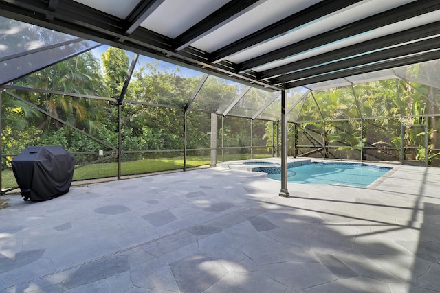 view of pool with a lanai, area for grilling, a patio area, and an in ground hot tub