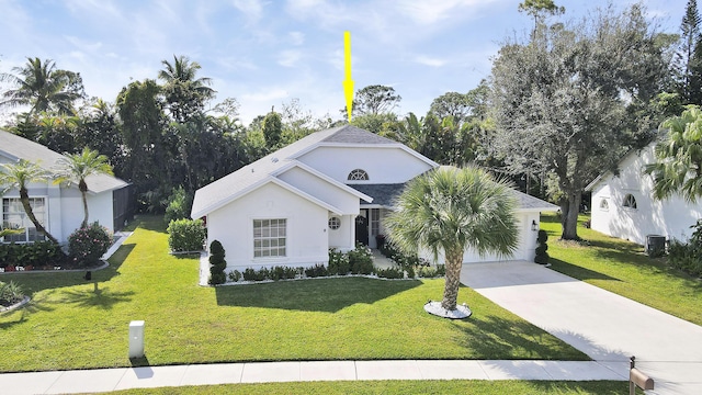 view of front of home featuring a front lawn and cooling unit