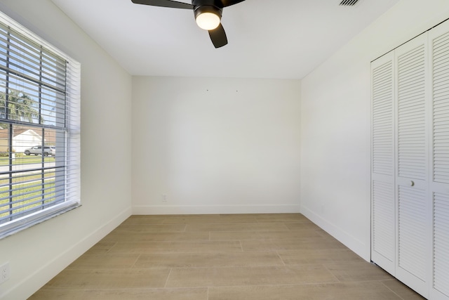 interior space with ceiling fan, a closet, and light hardwood / wood-style floors