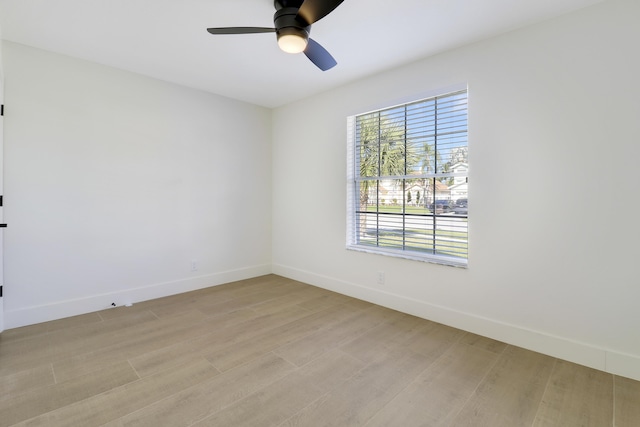 empty room with ceiling fan and light wood-type flooring