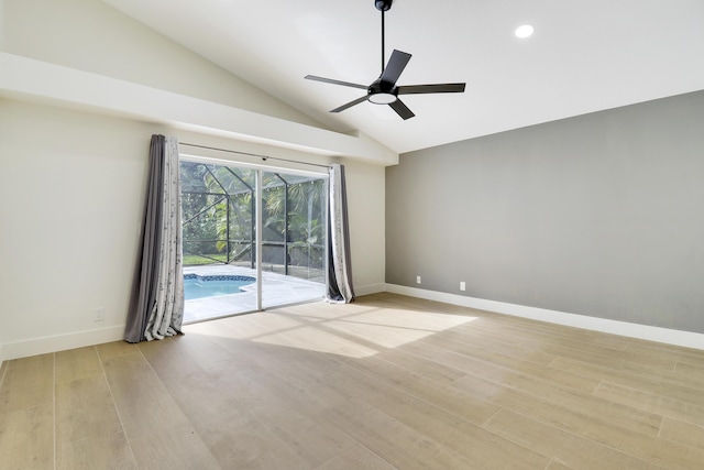 spare room with lofted ceiling, ceiling fan, and light hardwood / wood-style flooring