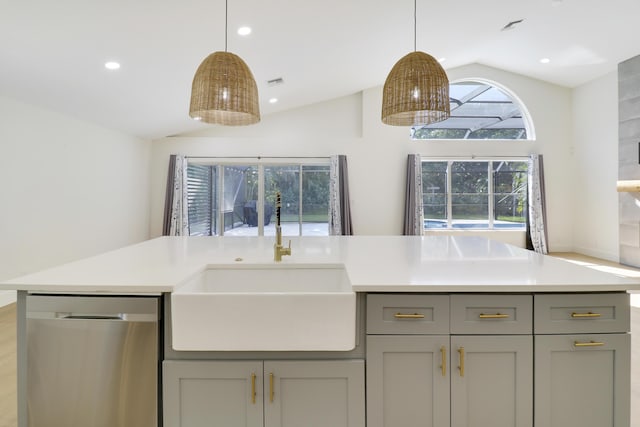 kitchen with sink, stainless steel dishwasher, gray cabinets, and vaulted ceiling