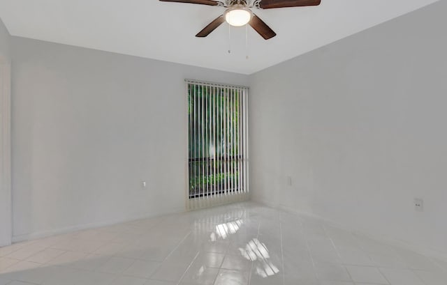 tiled empty room with ceiling fan