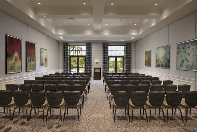 carpeted cinema room with coffered ceiling, beam ceiling, and ornamental molding