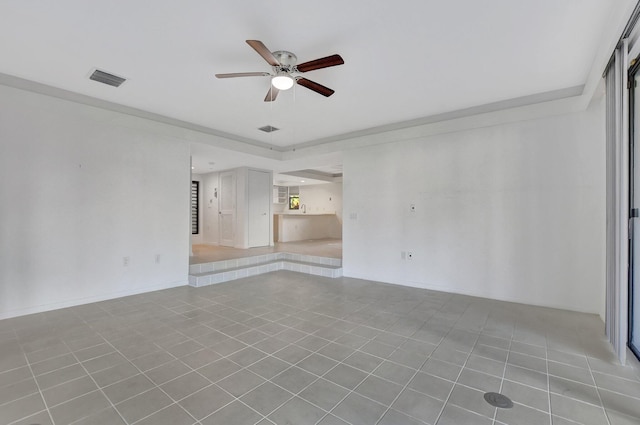 tiled spare room featuring ceiling fan