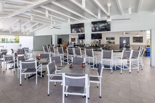 workout area with ceiling fan and high vaulted ceiling