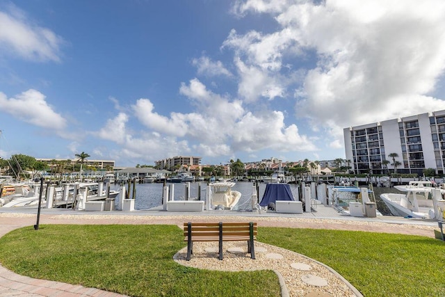 dock area with a water view and a lawn