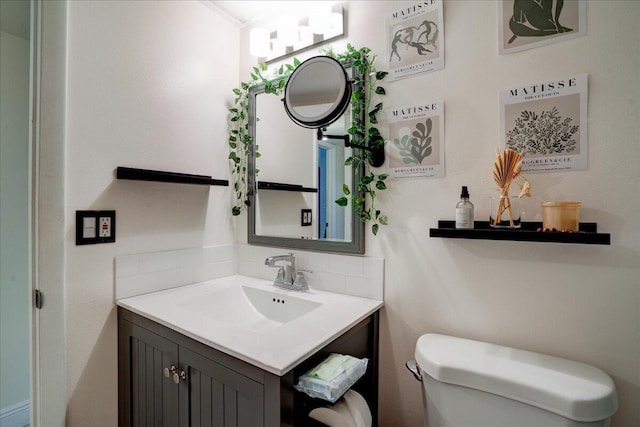 bathroom featuring vanity and toilet