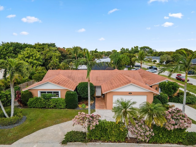 single story home featuring a garage and a front lawn