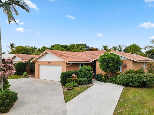 ranch-style home featuring a garage and a front lawn