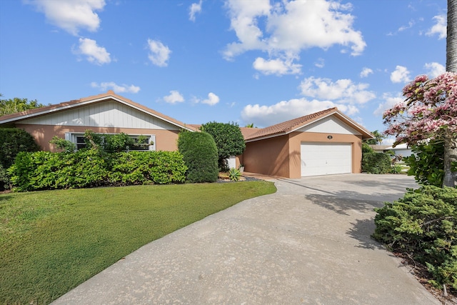 view of front facade with a garage and a front yard