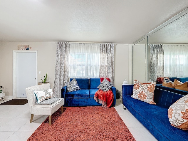 tiled living room with a textured ceiling and plenty of natural light