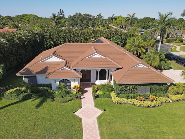 mediterranean / spanish-style house with a front yard