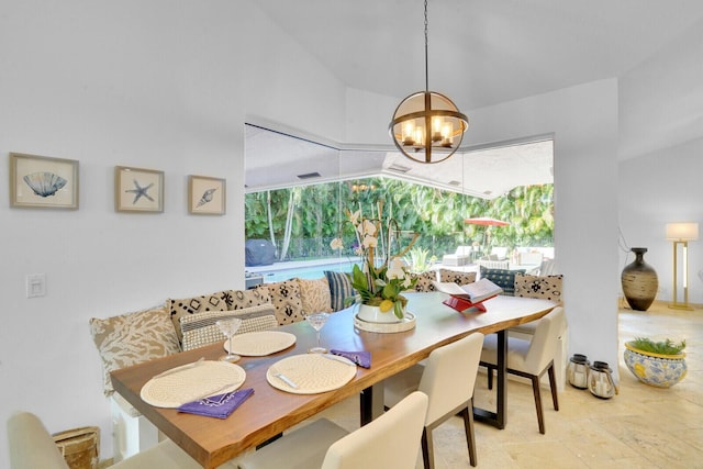 dining space featuring breakfast area and an inviting chandelier