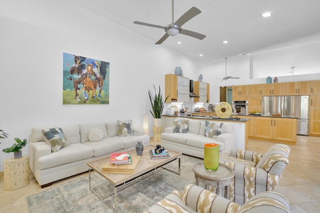 living room featuring a towering ceiling and ceiling fan