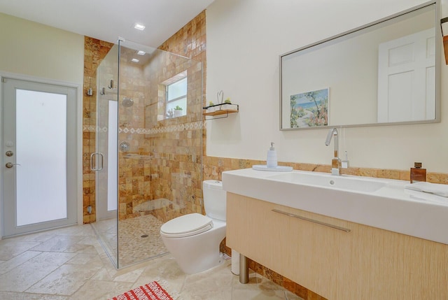 bathroom featuring vanity, toilet, and an enclosed shower