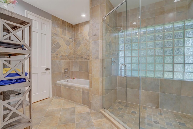 bathroom with shower with separate bathtub and tile patterned floors