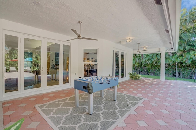 view of patio / terrace featuring ceiling fan and french doors