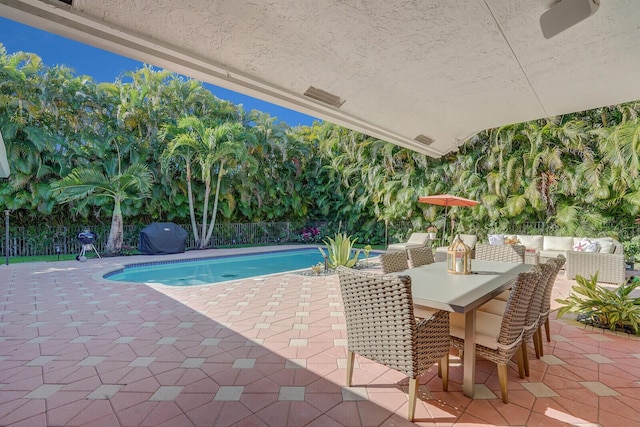 view of pool with an outdoor living space and a patio area