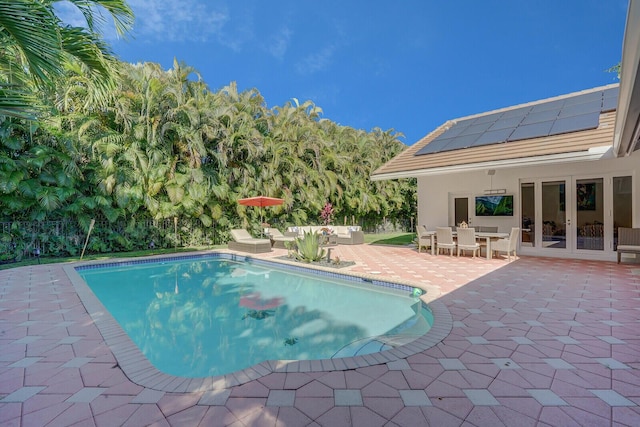 view of swimming pool with a patio area, french doors, and an outdoor hangout area