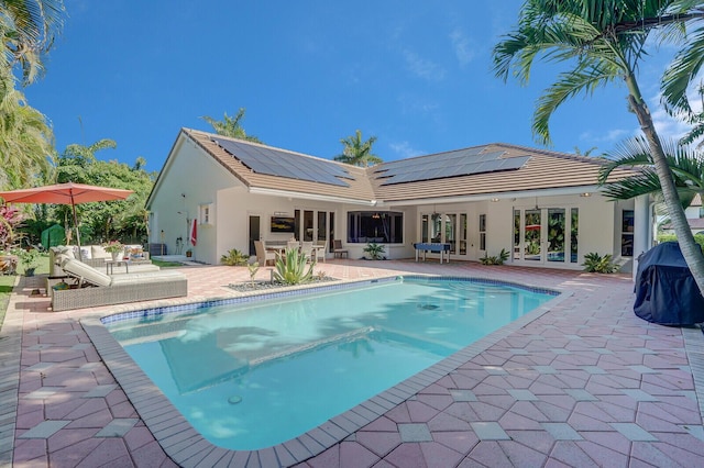 view of swimming pool with a grill, a patio area, and french doors