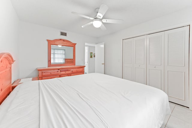 bedroom featuring a closet, ceiling fan, and light tile patterned floors