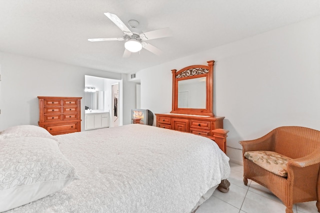 bedroom with ceiling fan, light tile patterned floors, and ensuite bathroom