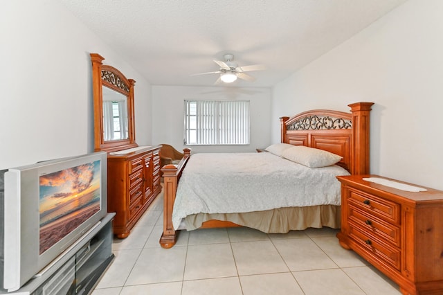 bedroom featuring light tile patterned flooring, a textured ceiling, and ceiling fan