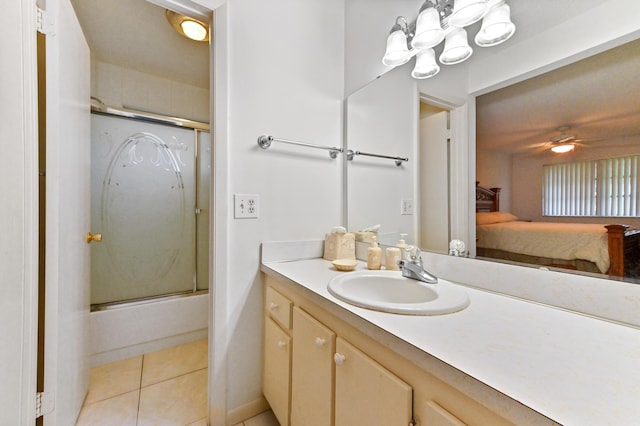 bathroom featuring vanity, ceiling fan with notable chandelier, combined bath / shower with glass door, and tile patterned floors