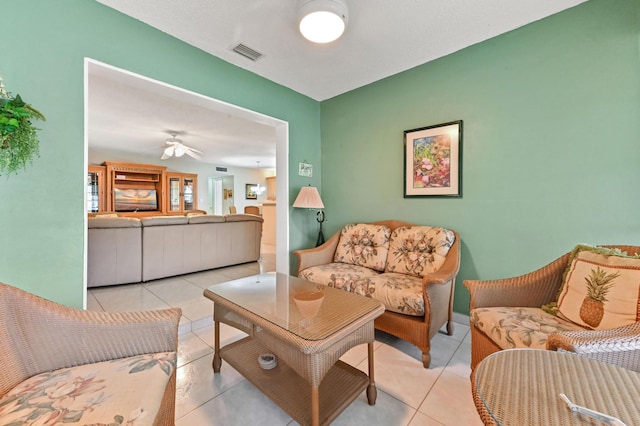 tiled living room with ceiling fan